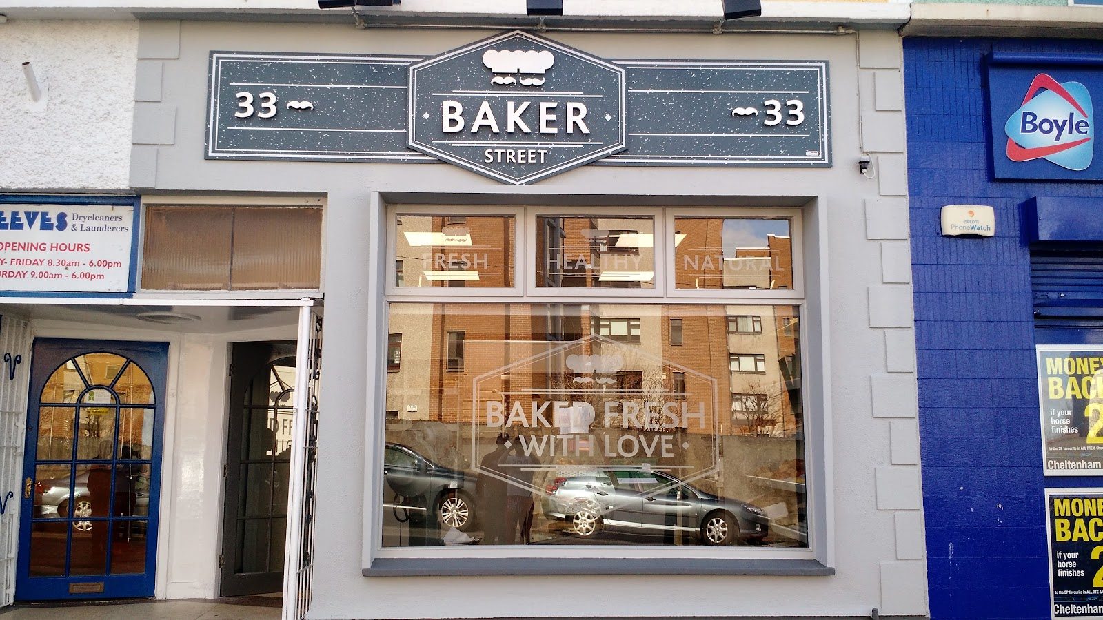 The Baker Street sign above the shopfront window on Glasthule Road, with 'Baked Fresh With Love' lettered on the glass